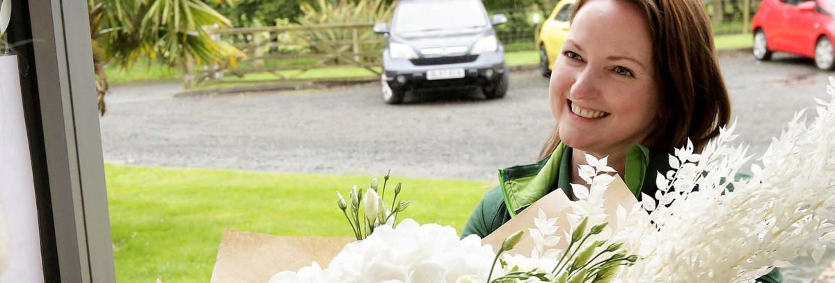 Our head florist Elaine Cherry delivering a bouquet of fresh flowers to a corporate client