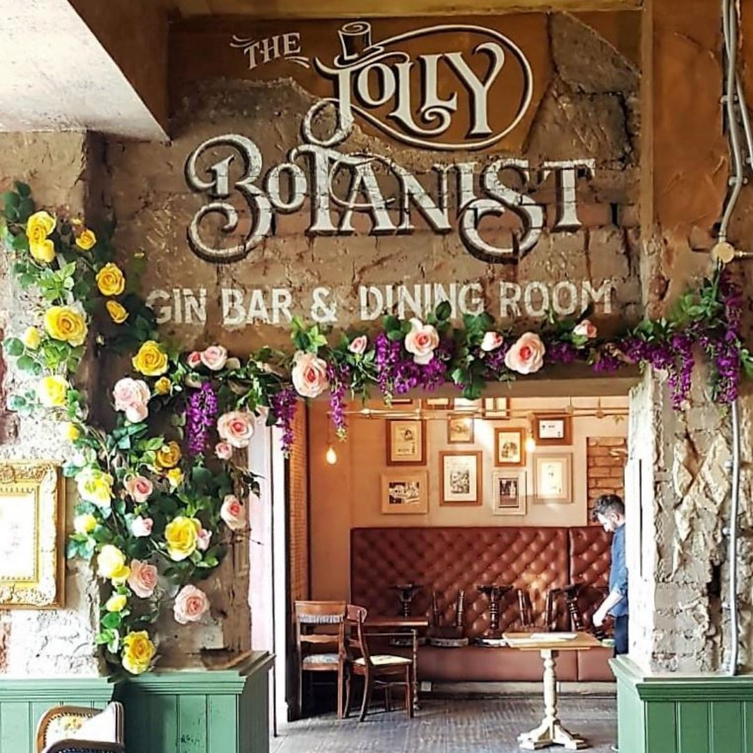 Jolly Botanist Gin Bar in Falkirk welcomes guests with a bespoke climbing vine of artificial roses, wisteria and foliage