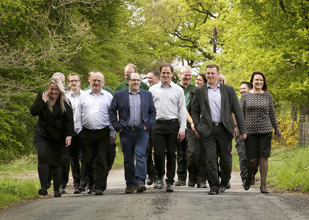 Benholm employee team walking through trees and plants