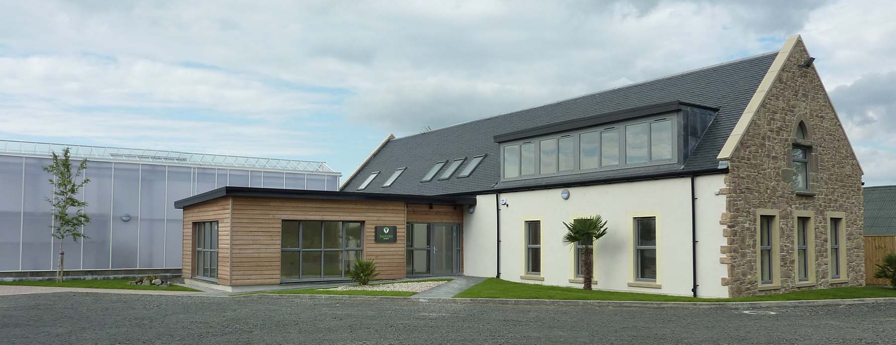 Benholm head office with lush greenery and plants on the outside