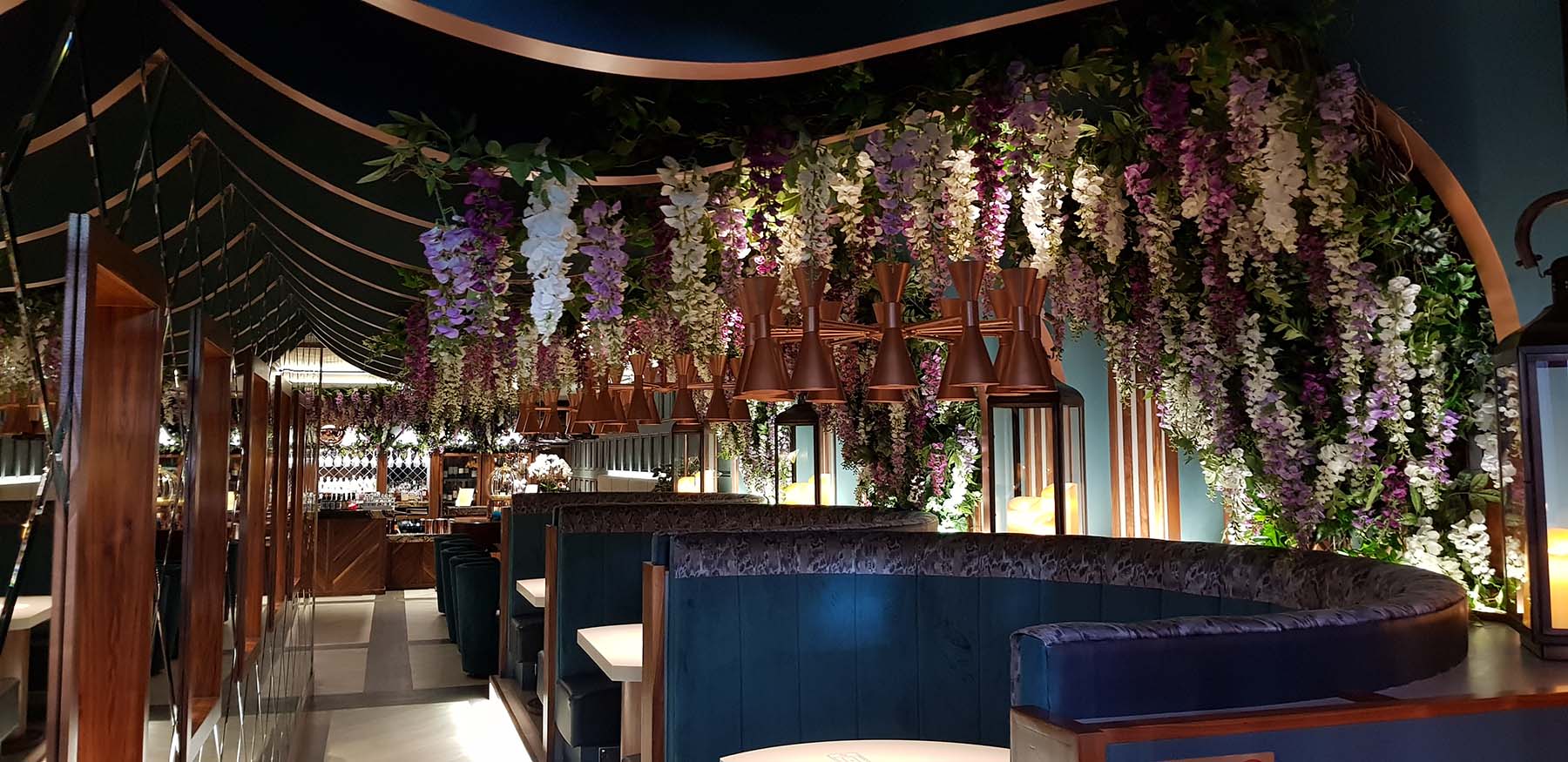 Beautiful trailing artificial foliage and festooned wisteria flowers create stunning atmosphere at Aberdeen Wine Bar