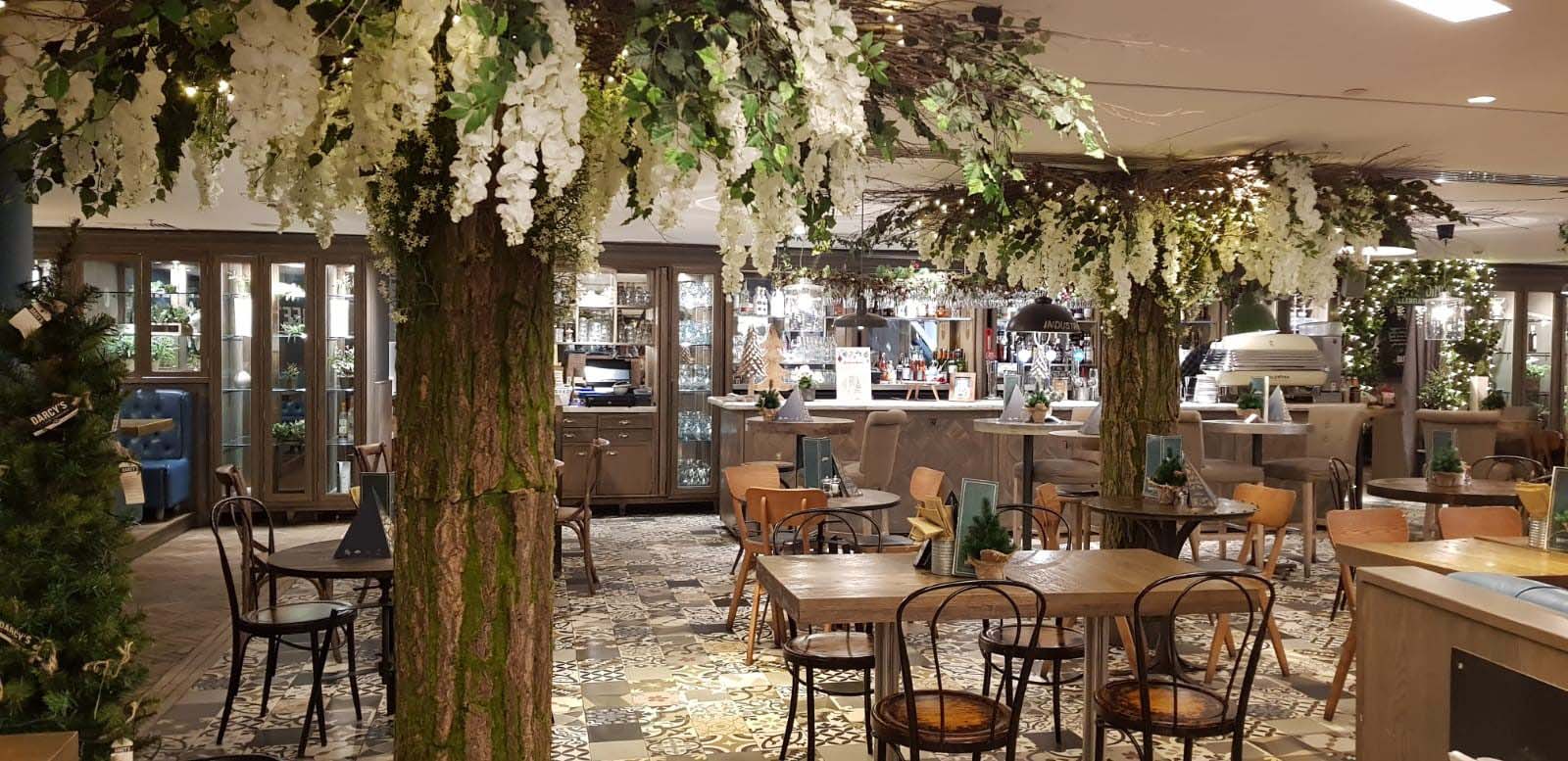 D’arcys bistro in Princess Square, Glasgow with twilight forest of bespoke artificial trees, lush greenery and thousands of twinkling fairy lights