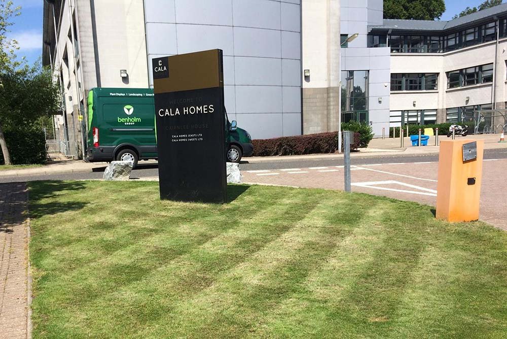 Lush green grass and manicured borders at Cala Homes head office to welcome staff and guests