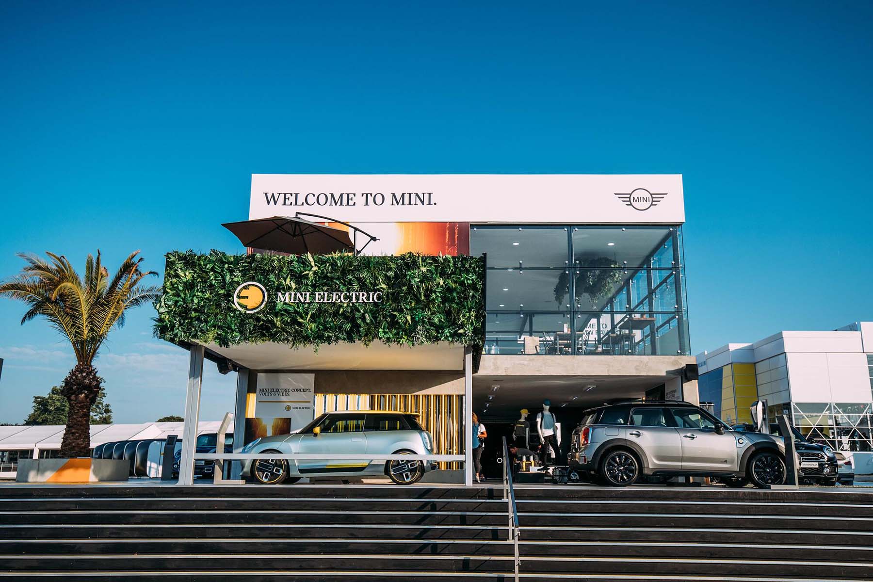 Mini Cooper stand at Goodwood Festival introducing the Electric model with highly visible branded artificial green wall