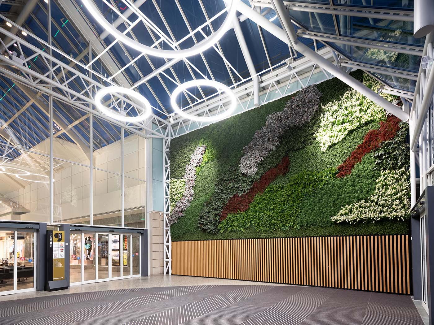 Beautiful green wall with swathes of varied artificial plants and Nordik Moss welcomes shoppers at Gyle Centre Edinburgh