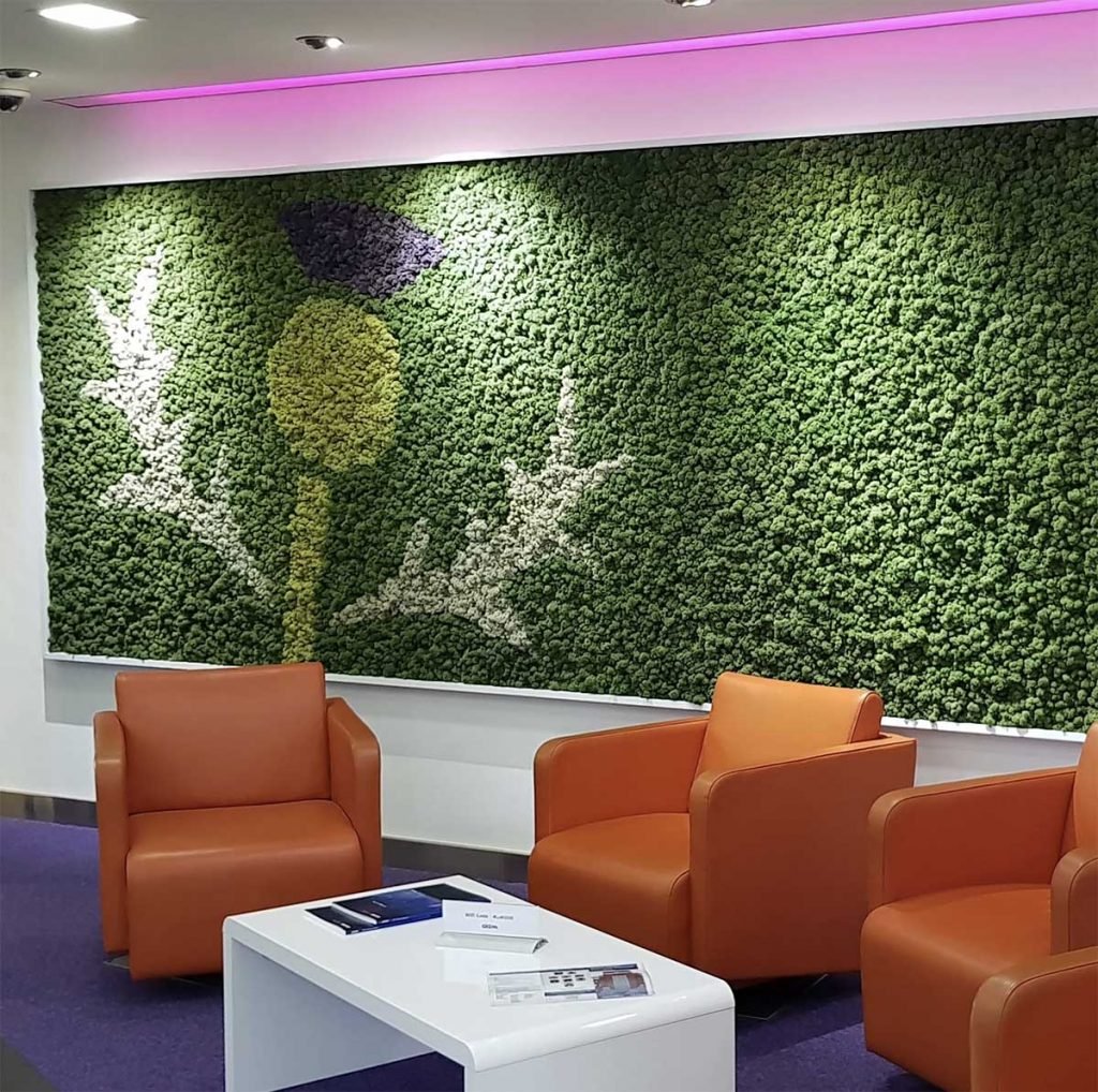 Bespoke Nordik moss wall with a hand crafted thistle shape on a feature wall behind orange chairs in a reception space
