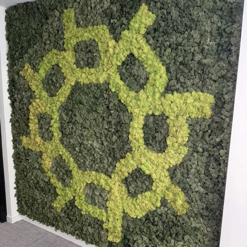 Two colours of green moss make up a bespoke moss wall featuring an intricate logo bade up of circular letter b’s