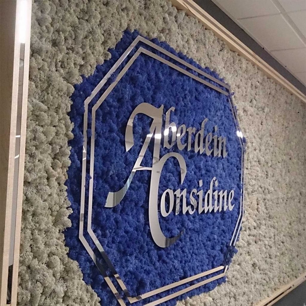 Aberdein Considine feature wall crafted from white Nordik Moss with blue moss to outline the company’s logo