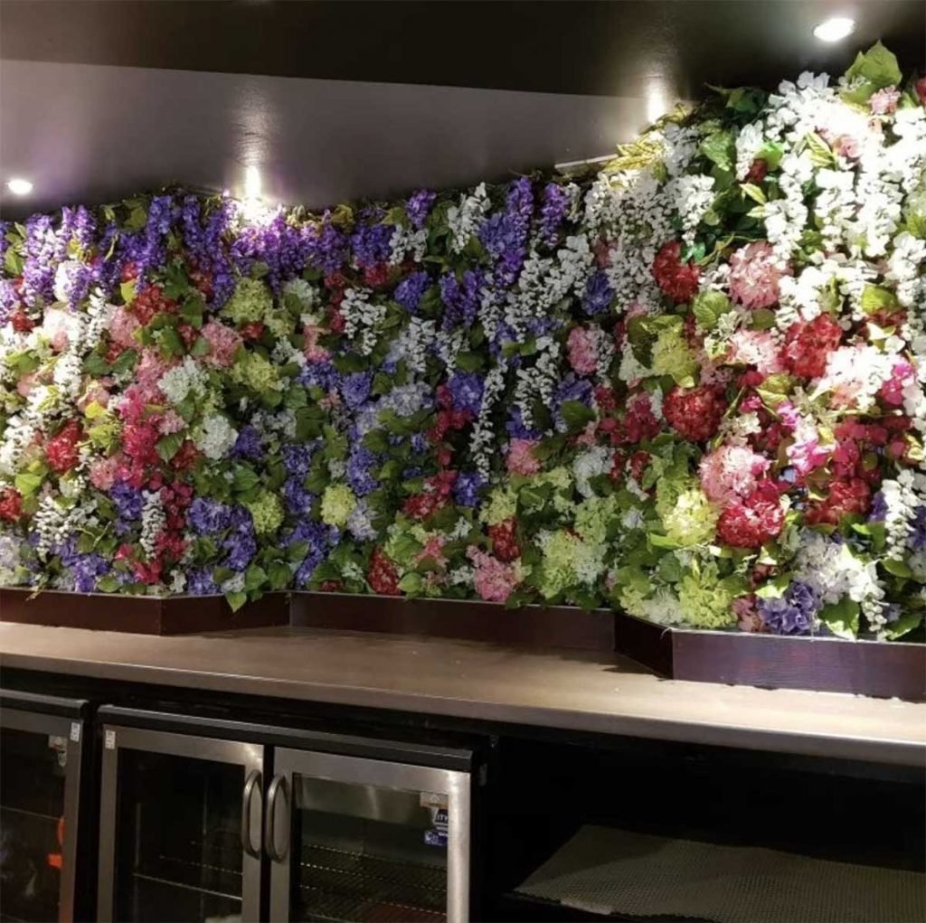 Brewhemia bar in Edinburgh’s internal wall panel custom made and filled with artificial blooms and greenery