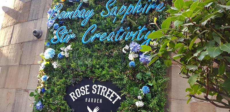 Brewhemia Edinburgh stunning exterior floral archway bursting with colourful artificial flowers and lush greenery