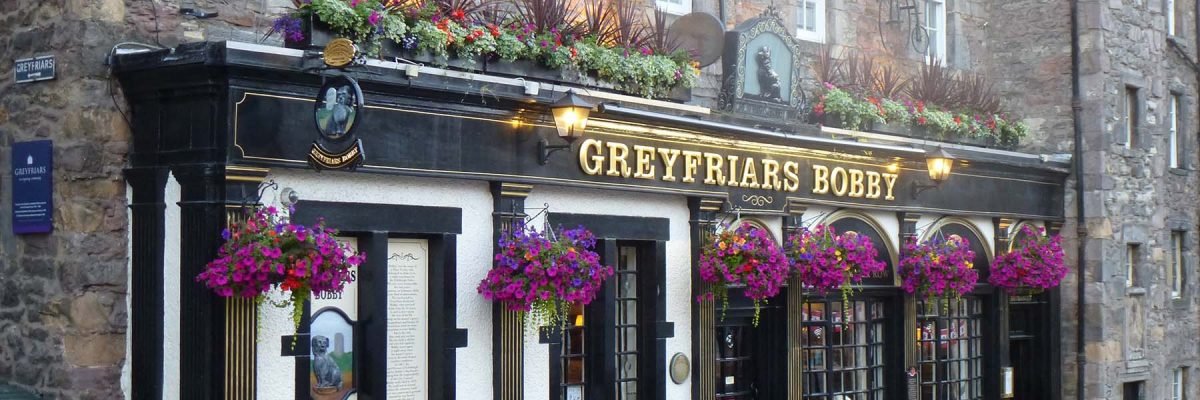 Bright blooming hanging baskets create a warm welcome at the famous Greyfriars Bobby pub in Edinburgh’s old town