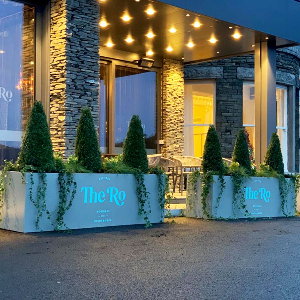 live buxus pyramids and trailing ivy set in branded planters to create a stunning impact at the entrance to the Ro Hotel in Windermere.