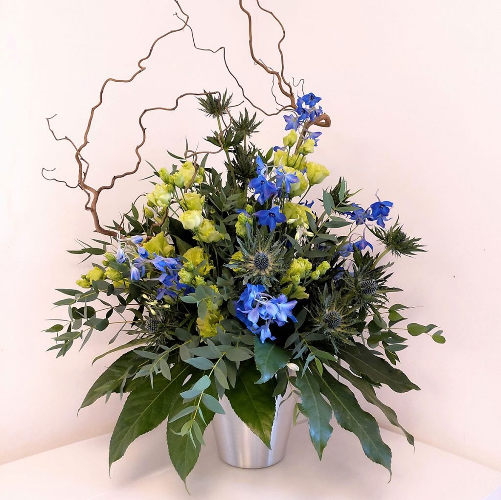 gorgeous scottish themed corporate display featuring twisted willow branches, delphinium and lisianthus