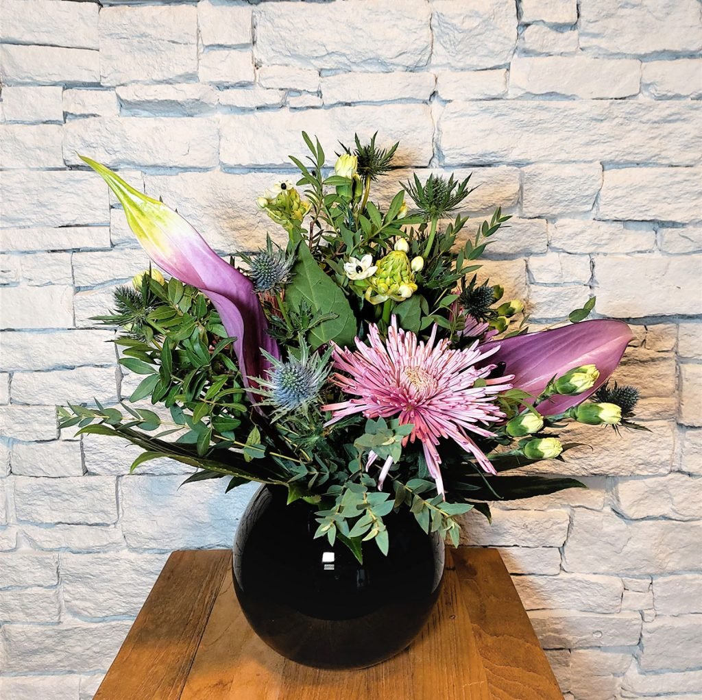 small corporate bowl vase display with chrysanthemums, thistles, lisianthus and anthuriums