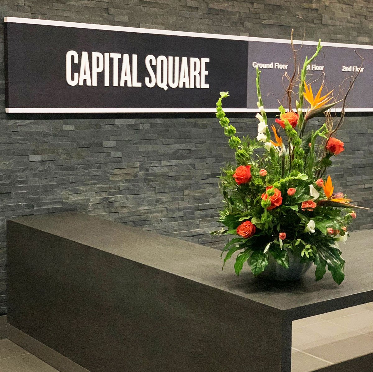 gorgeous reception flower display at capital square edinburgh featuring birds of paradise and roses
