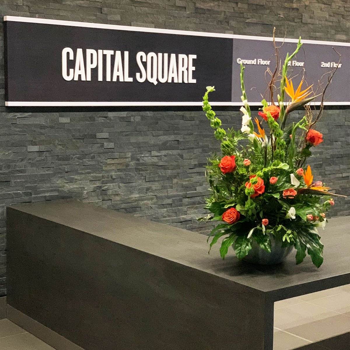 a vibrant reception flower display at capital square edinburgh featuring birds of paradise and roses