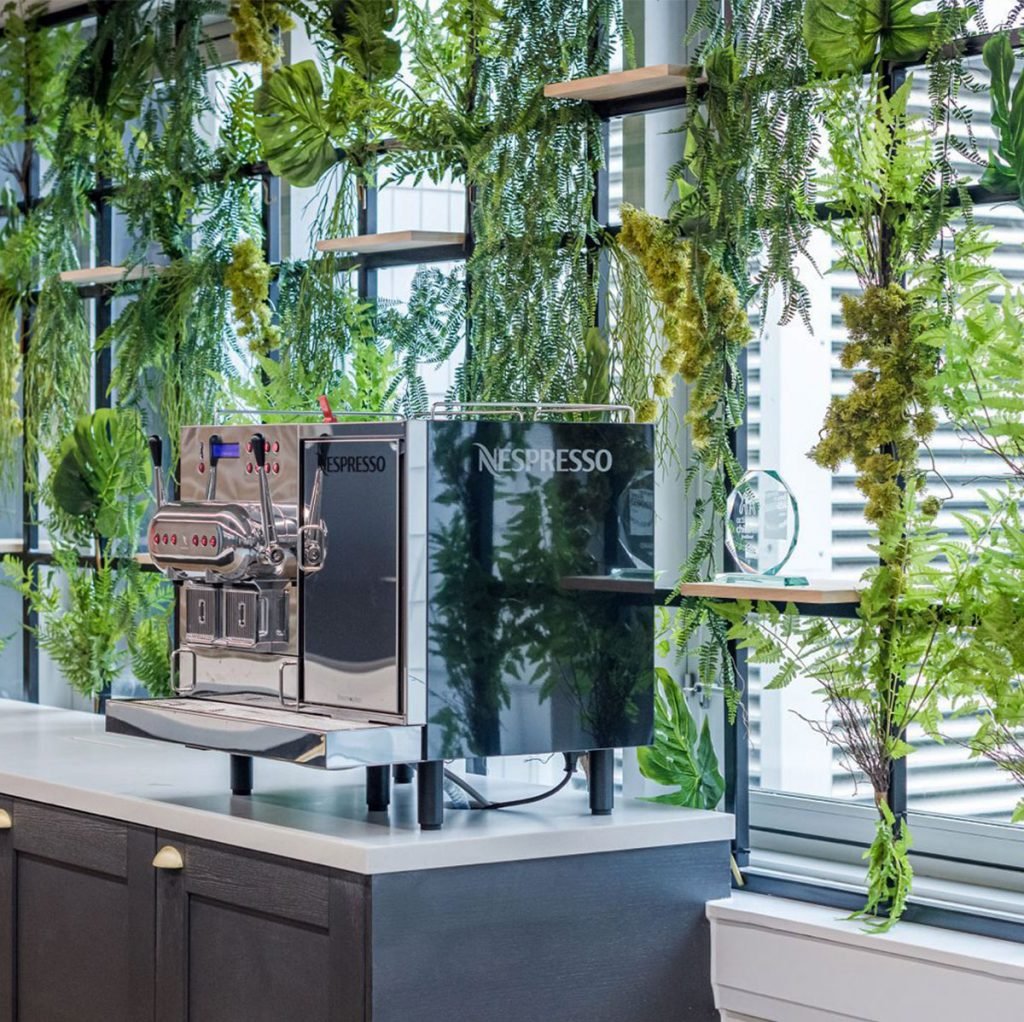 window trellis covered with artificial plants and tropical leaves to create a subtle privacy screen
