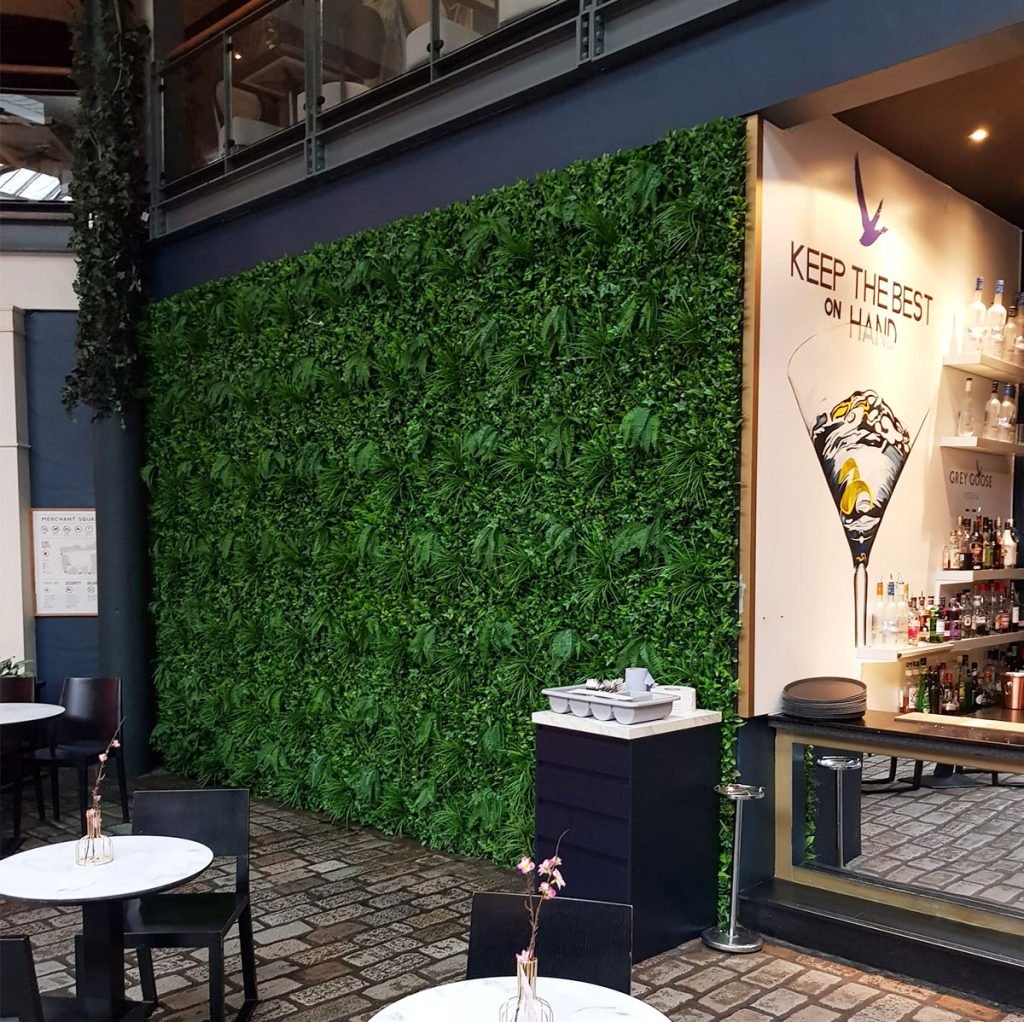 artificial green wall anchors this interior and enhances the welcoming atmosphere.