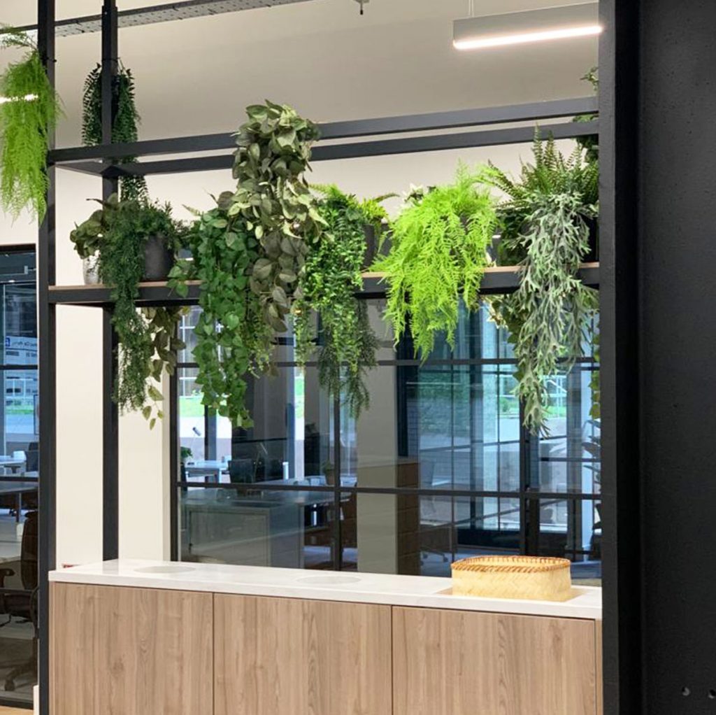 artificial green trailing plants soften this corporate environment and bring natural beauty to the modern interior