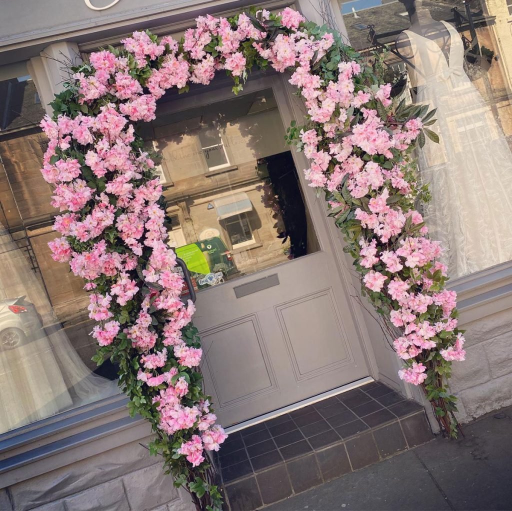 beautiful bespoke built exterior archway with pink cherry blossom for a 'spring look' and built so that the flowers can be changed throughout the seasons