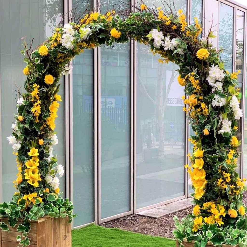 Bespoke built floral archway set into movable timber planters - a beautiful statement entrance arch that can easily be removed when necessary