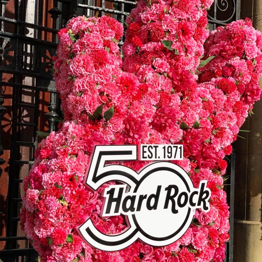 bespoke built floral guitar in hot pinks with an acrylic sign, created to celebrate the 50th anniversary of hard rock cafe in glasgow