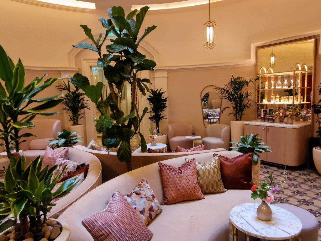 Live mixed planting interspaced with the plush sofas create a lovely touch to this plant-filled room in the Virgin Hotel, Edinburgh