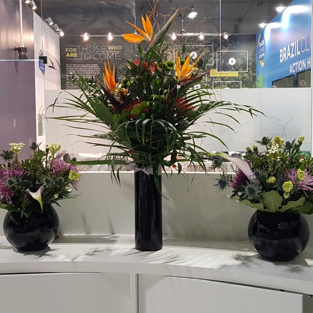A lovely tropical floral arrangement for the COP26 event amongst two smaller floral bouquets