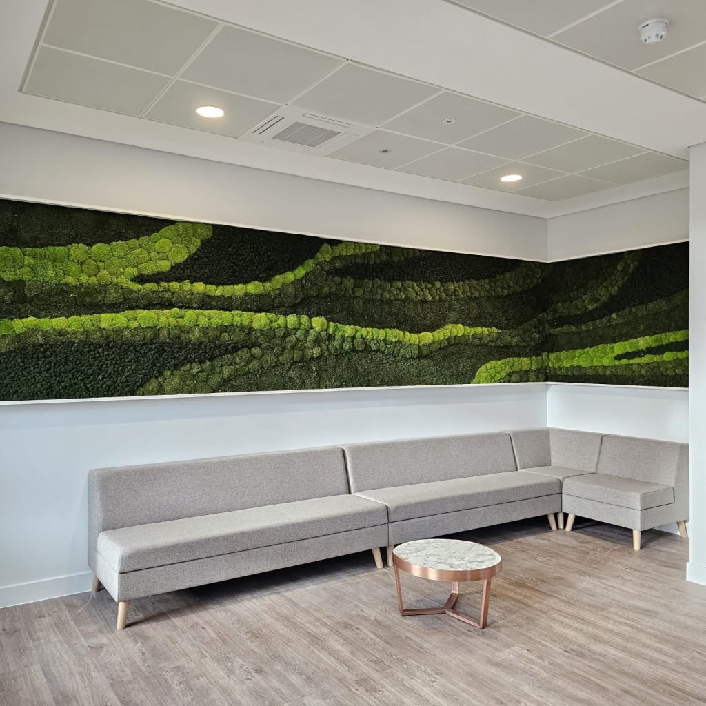 A beautiful Nordik moss wall featuring bun, flat and reindeer moss in varying shades of green create a pattern on the walls of this corporate space
