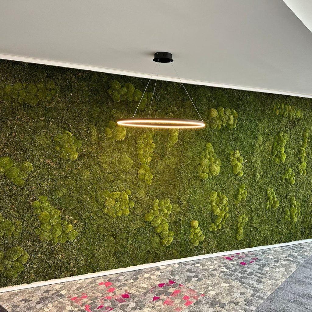 a large mixed nordik moss wall with forest green bun and flat moss for an office area