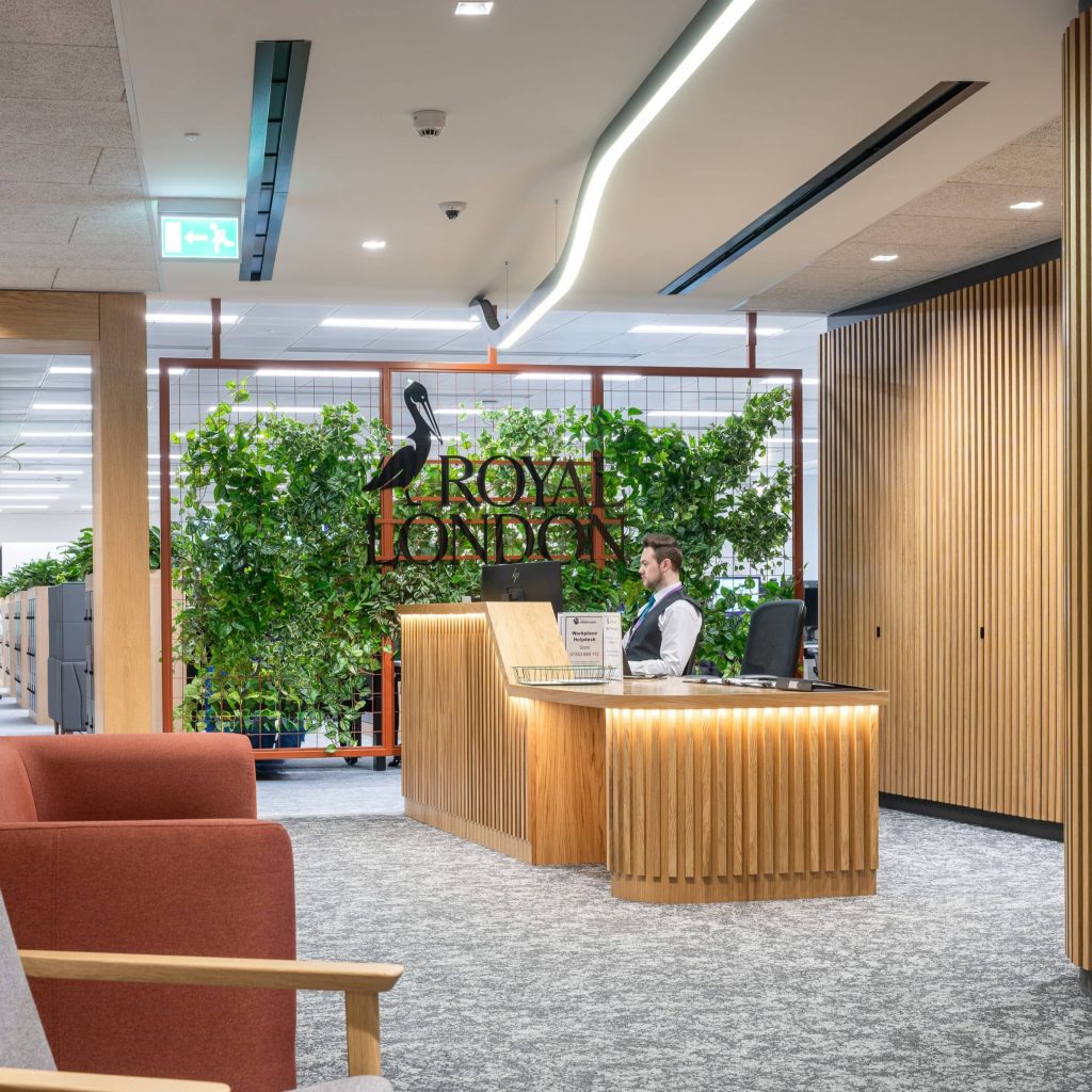 A bespoke artificial green wall with signage at Royal London Edinburgh's reception desk